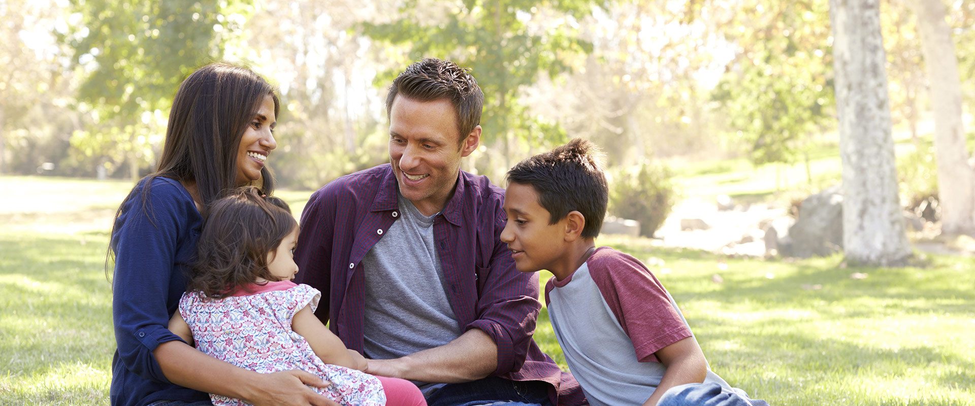 A family sits at a park