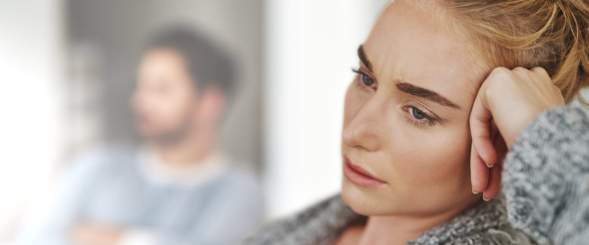 Image of a woman in the foreground and a man in the background